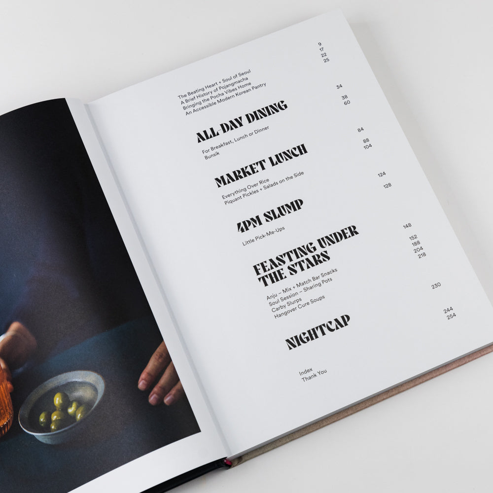 Open book with menu items listed on a white background