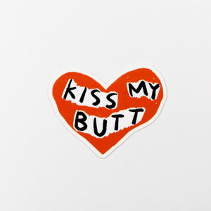 Heart-shaped sticker with 'KISS MY BUTT' text on a white background