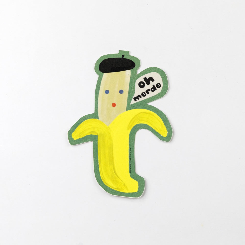 Banana-shaped sticker with a face and text on a white background