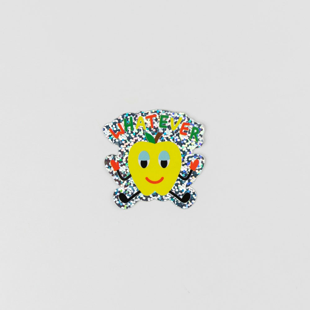 Colorful holographic cartoon apple sticker with 'Whatever' text on a light gray background