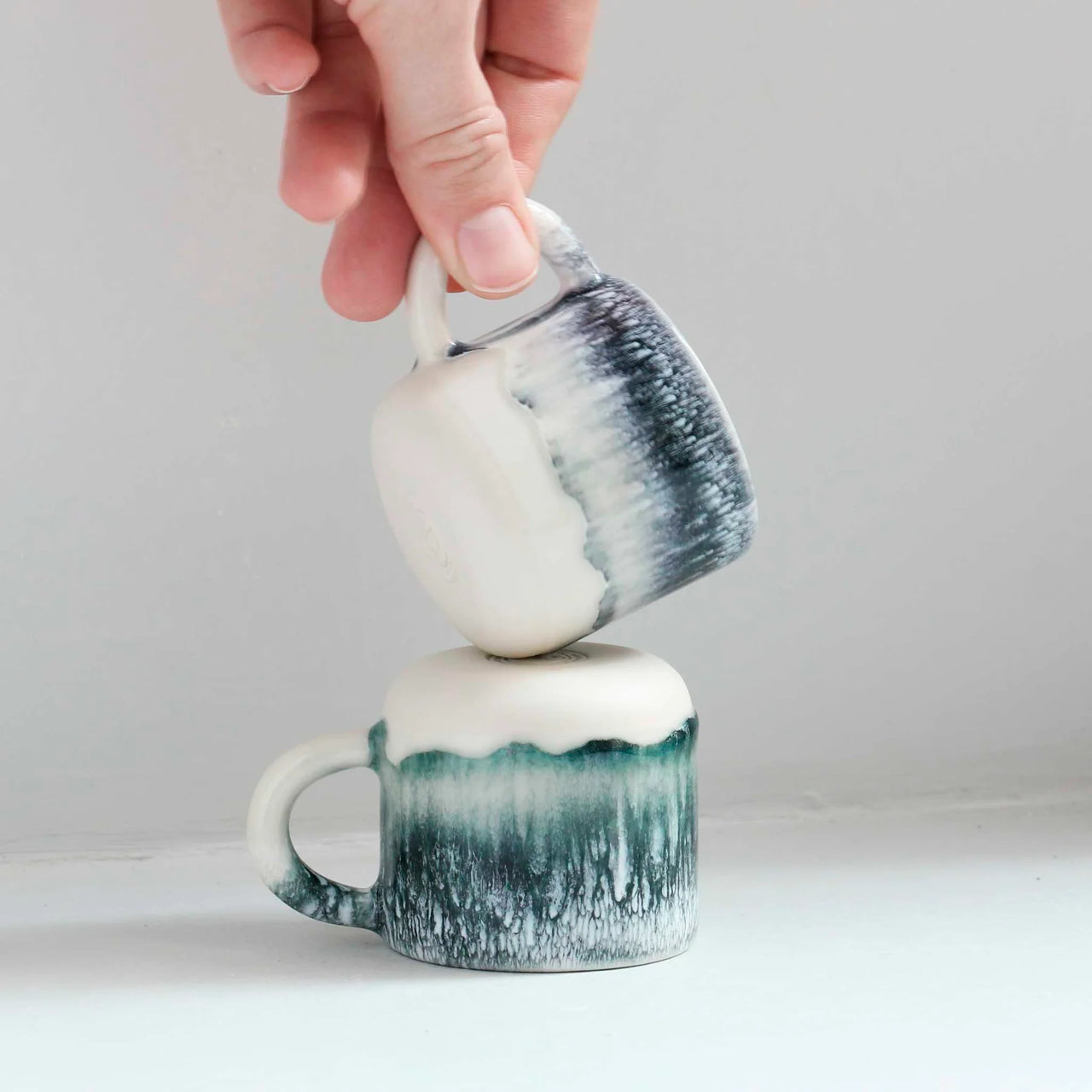 Ceramic mug with black to white gradient on a white background