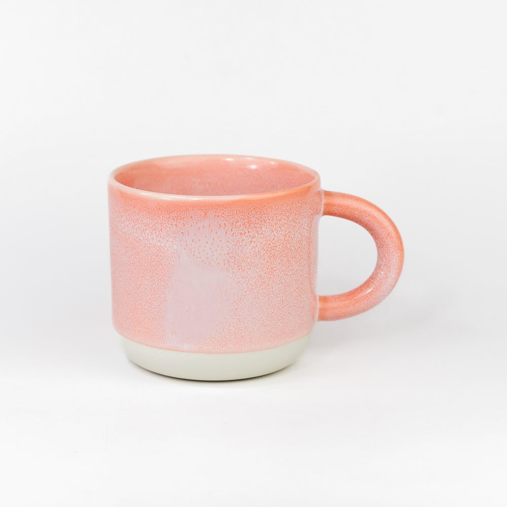 Pink ceramic mug on a white background
