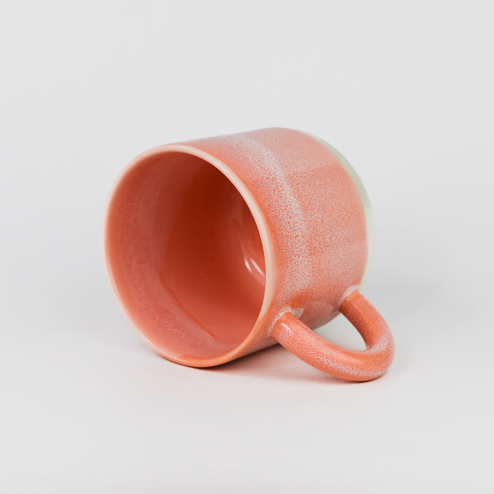 Ceramic mug with a textured surface on a light gray background