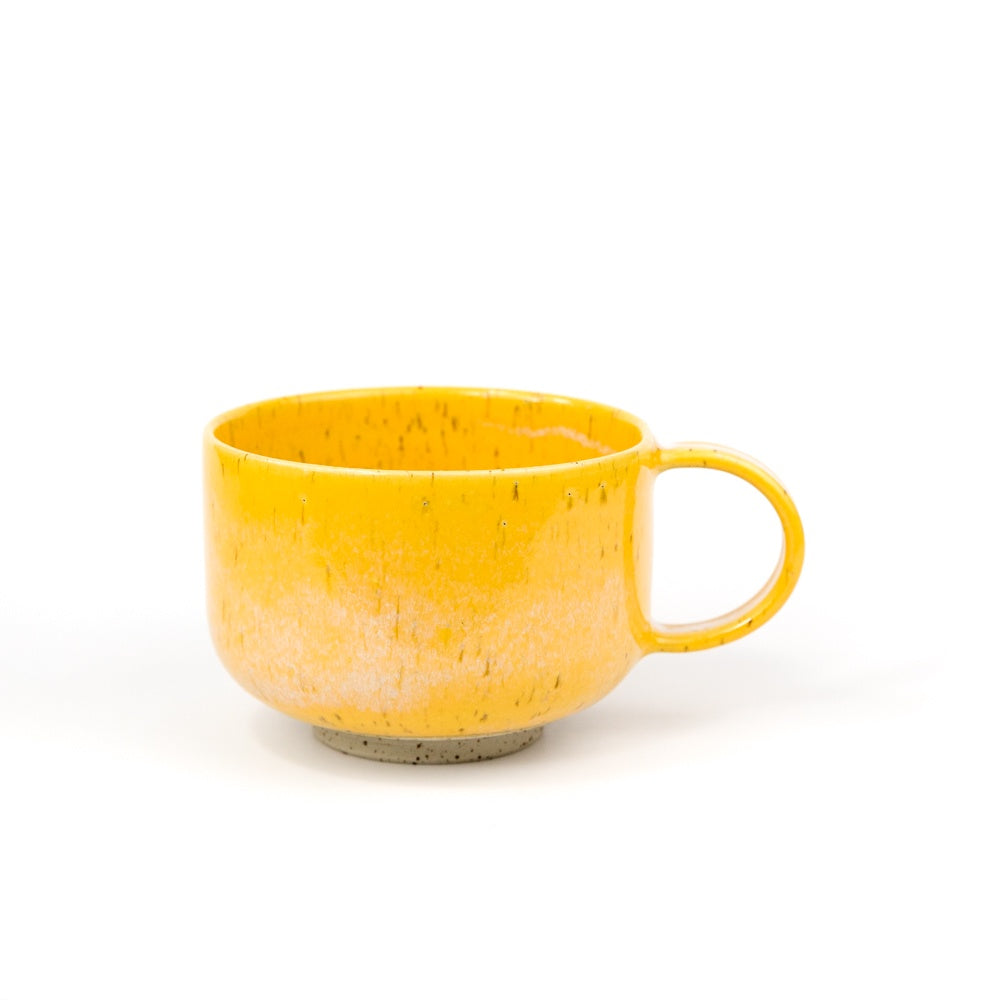 Yellow ceramic mug on a white background