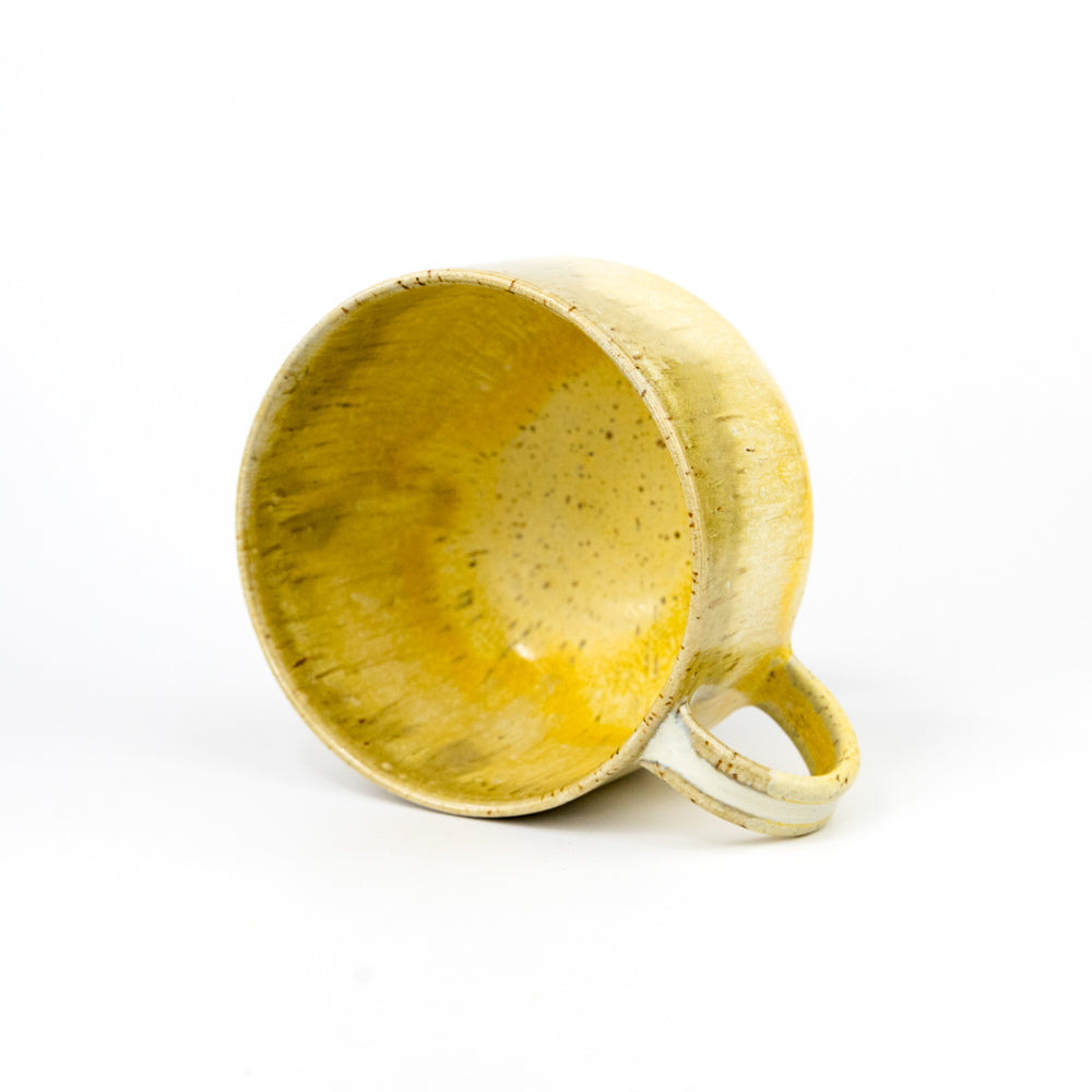 Yellow ceramic mug on a white background