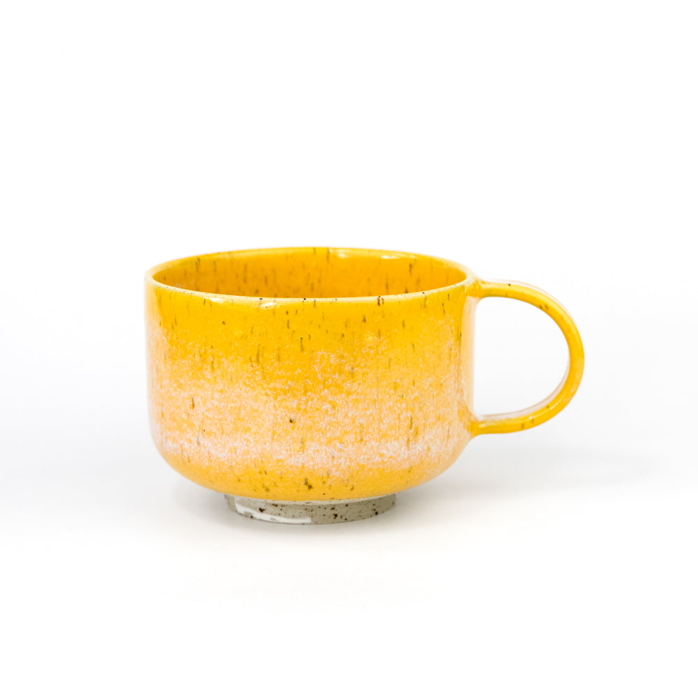 Yellow ceramic mug on a white background