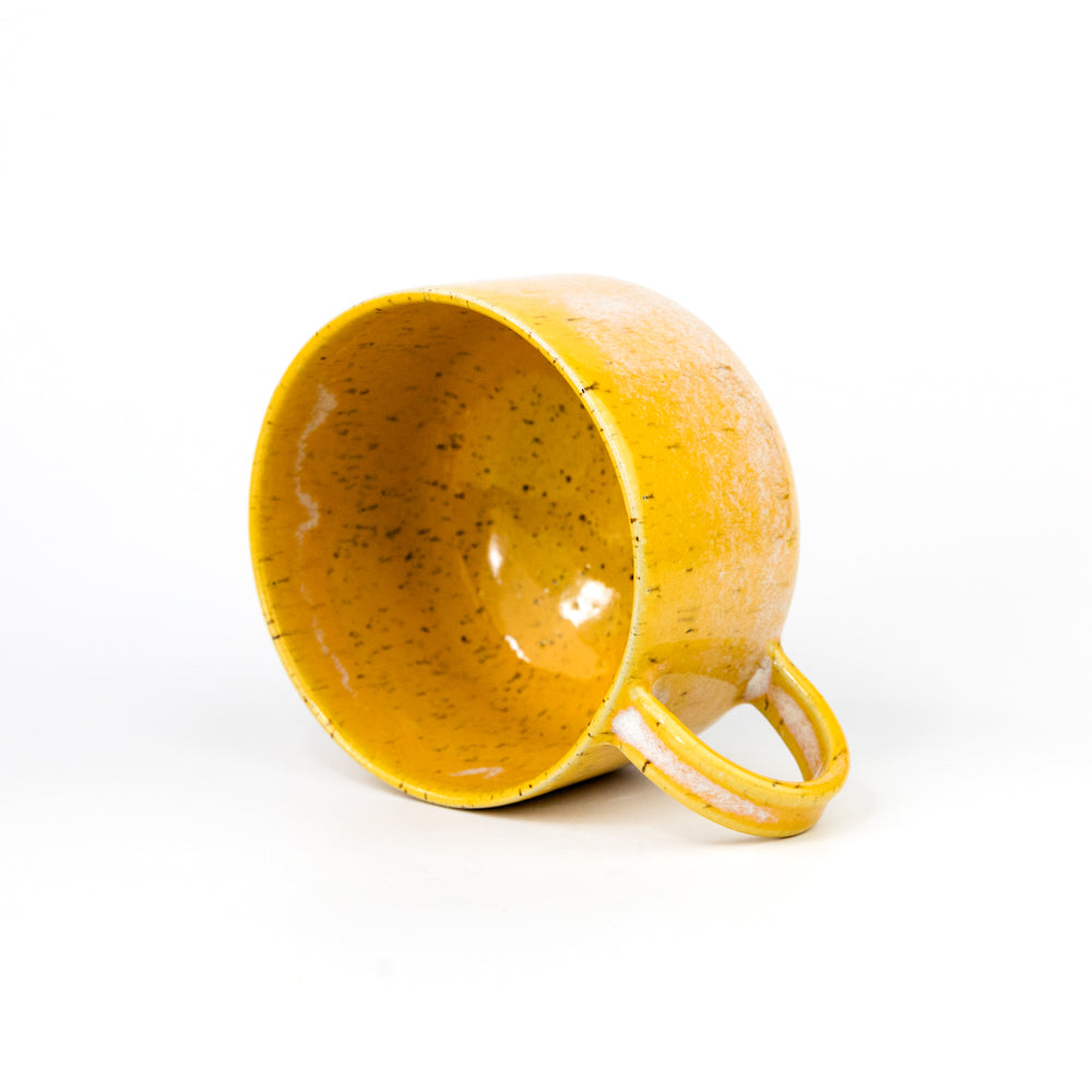 Yellow ceramic mug on a white background