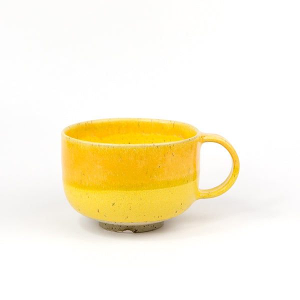 Yellow ceramic mug on a white background