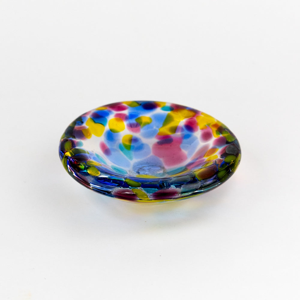 Multicolored glass dish on a white background
