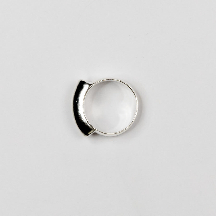 Silver ring on a light gray background