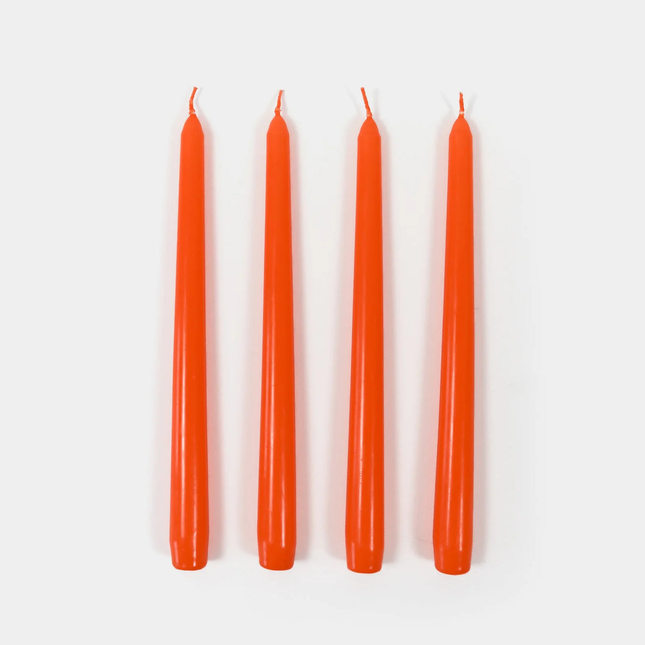 Four orange candles on a white background