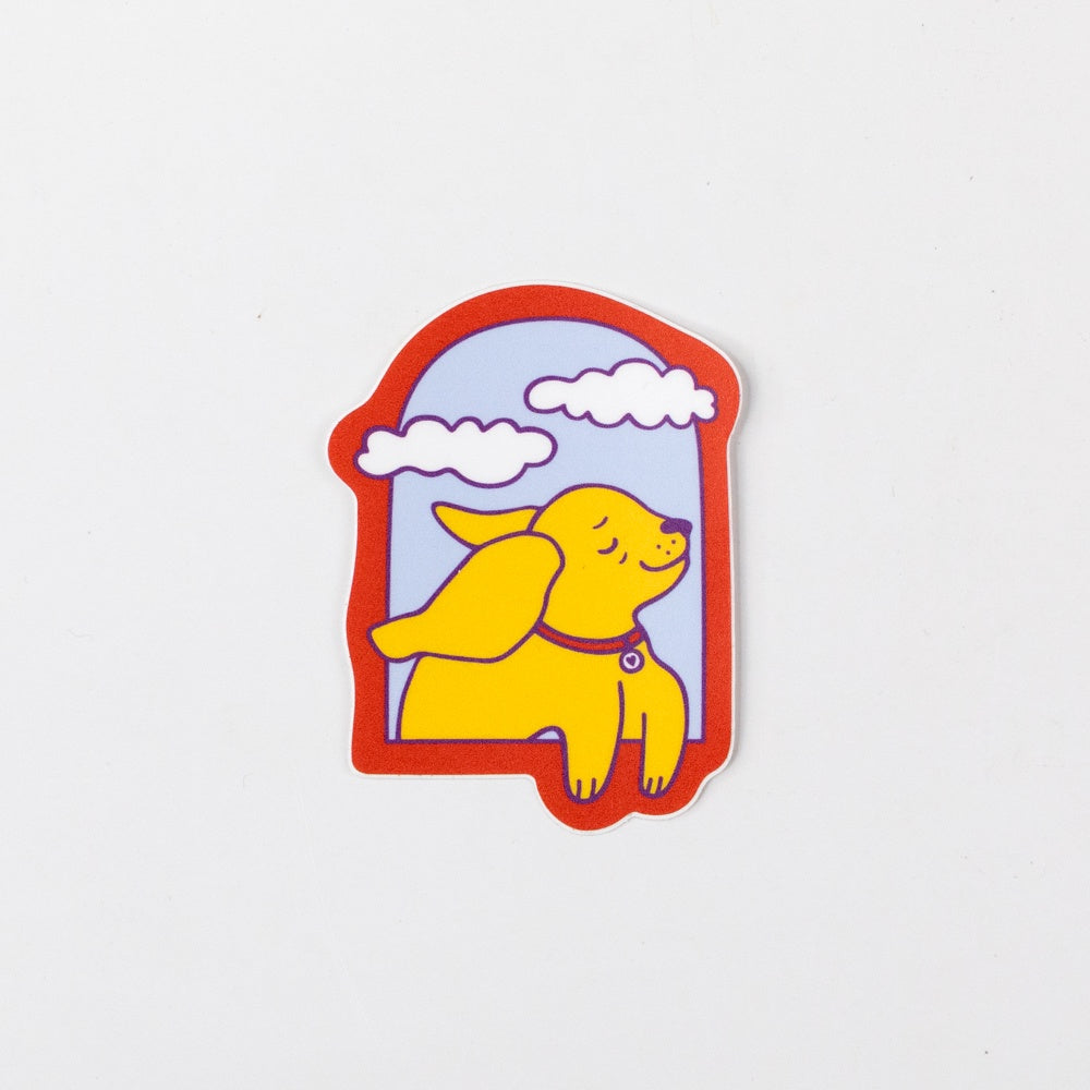 Sticker of a yellow dog with a red border on a white background