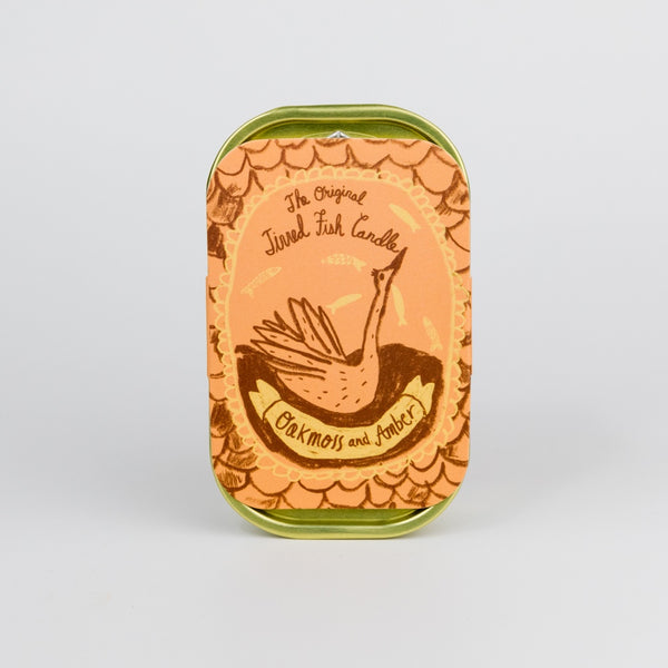Packaging of a tinnedcandle with decorative swan design and text on a white background