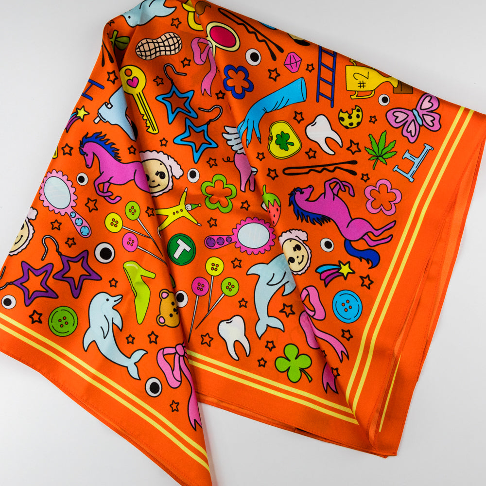Orange scarf with colorful patterns on a white background