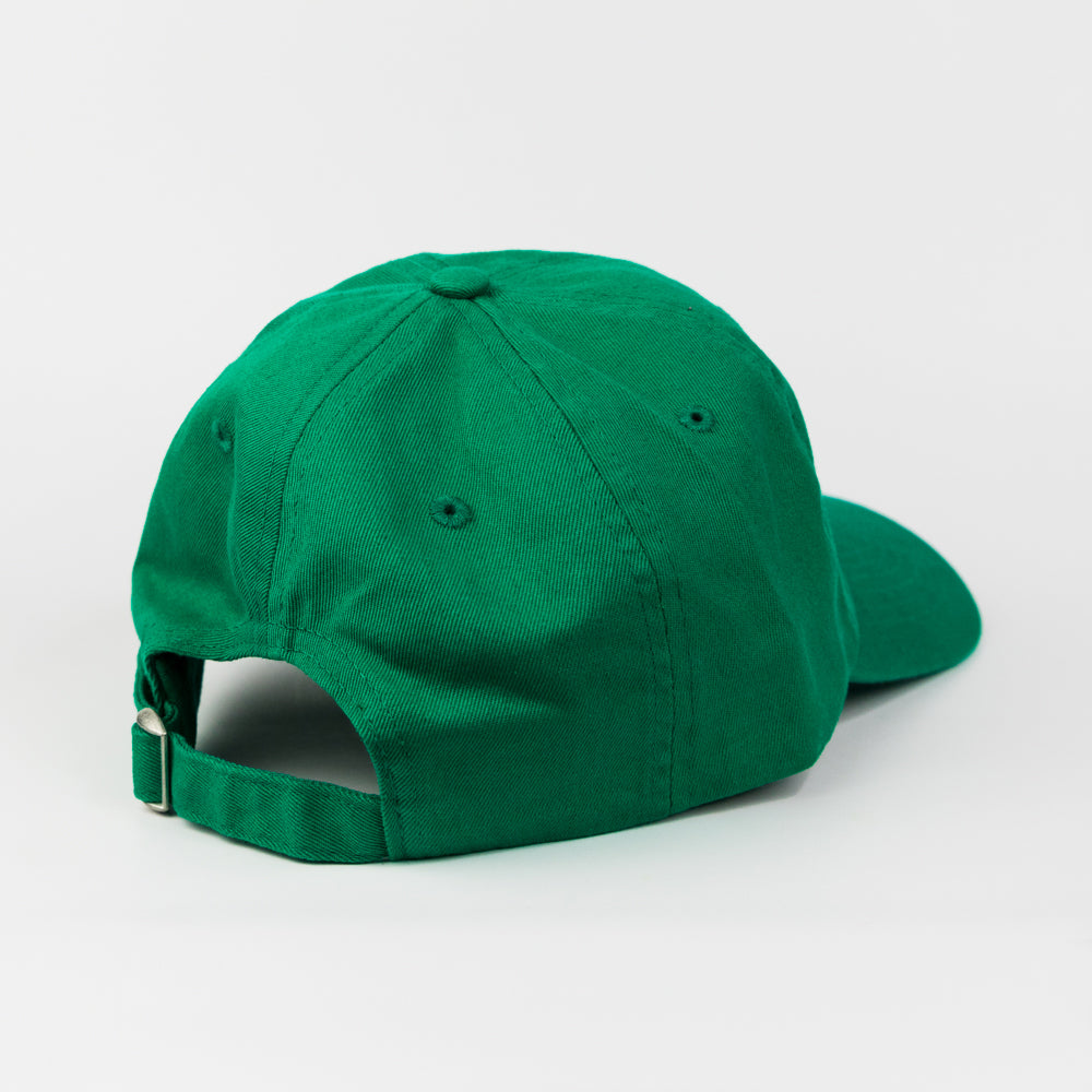 Green cap with red text 'tomato basil' on a light gray background