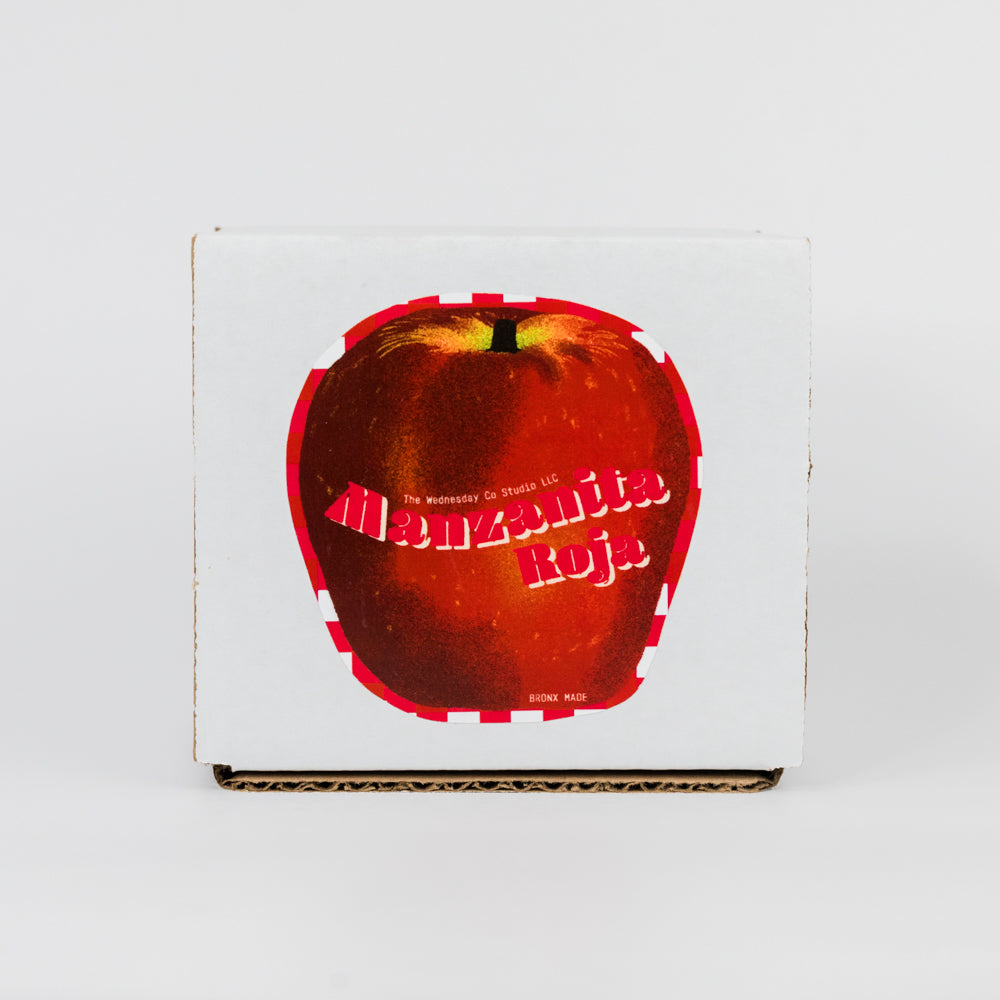 Book with a red apple illustration on the cover against a white background