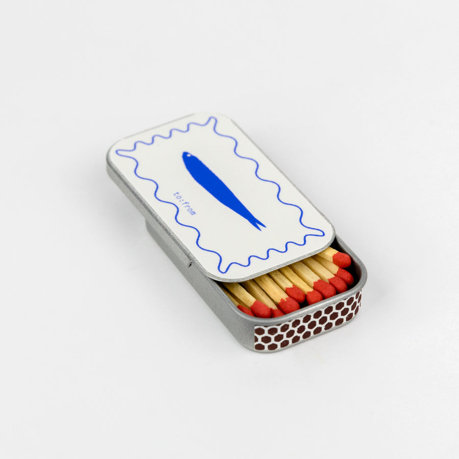 a tin mathcbox with a blue fish design on it