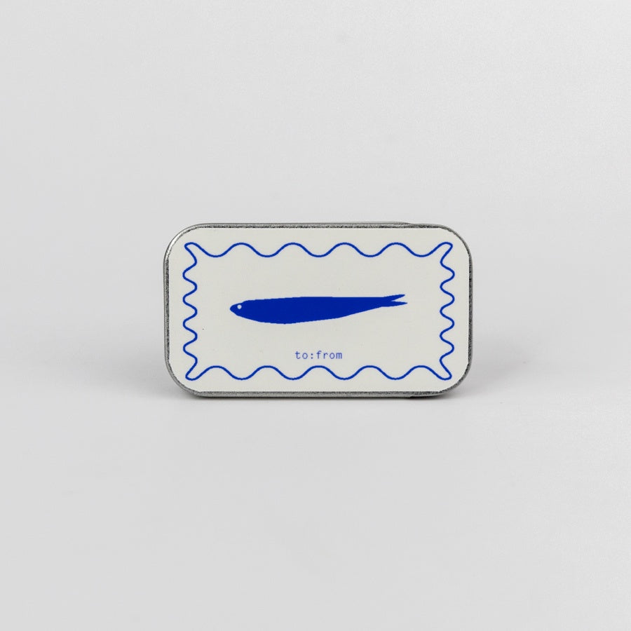 a tin mathcbox with a blue fish design on it
