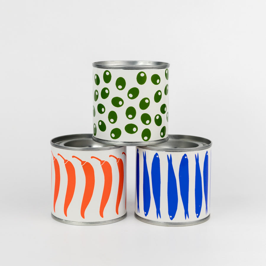 Metal can with red and white chili pepper design on a light gray background
