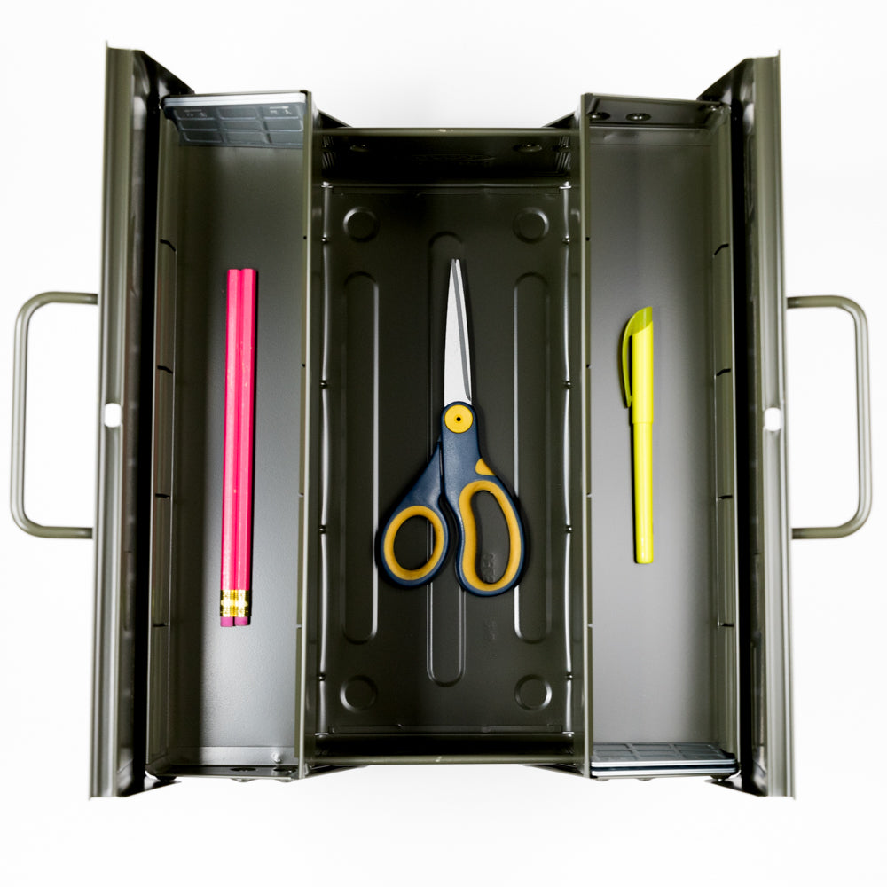 Metal toolbox with tools including a pink pencil, scissors, and a yellow knife.
