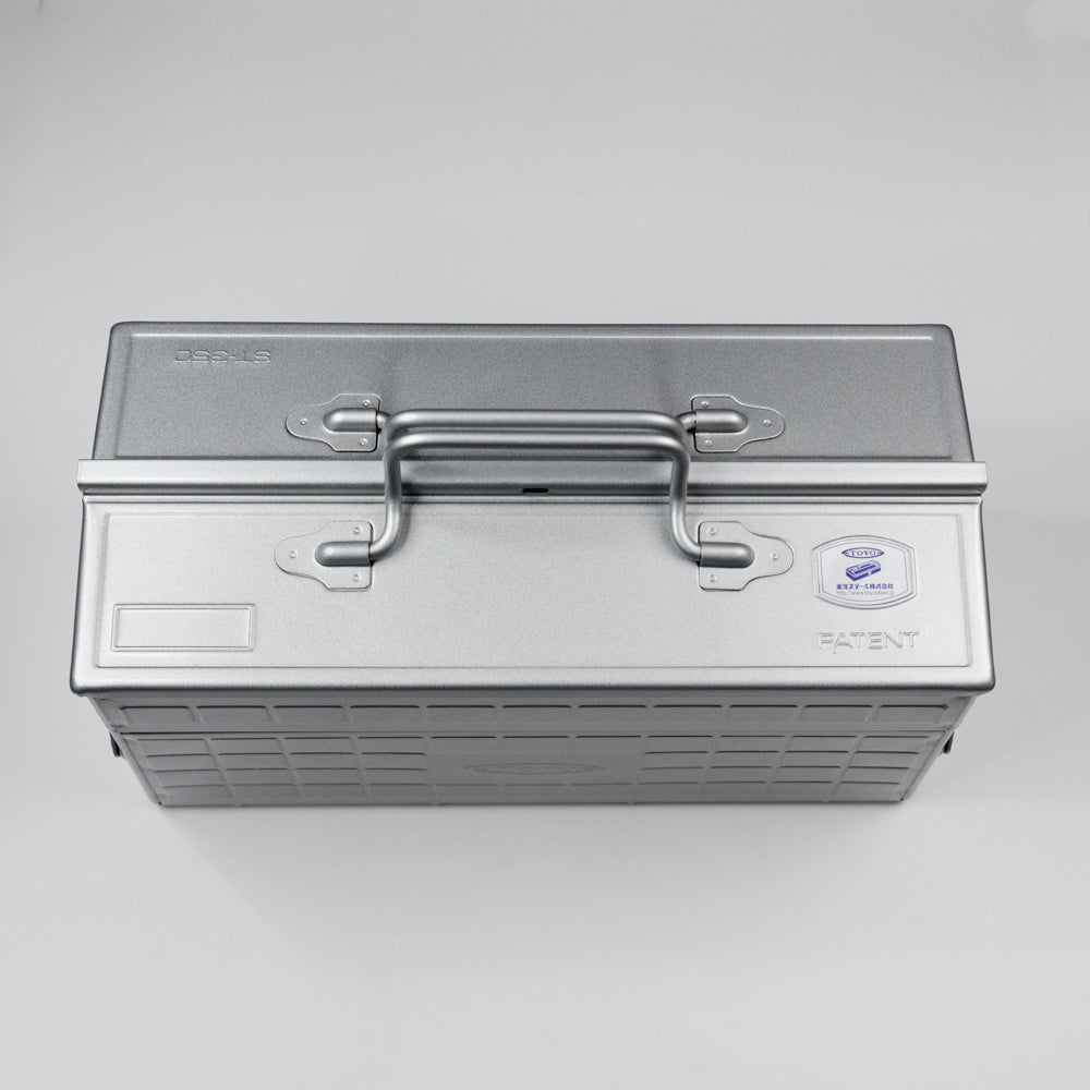 Metallic toolbox with a handle on a gray background