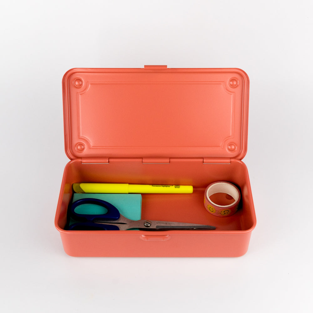 Open orange toolbox with stationery items on a white background