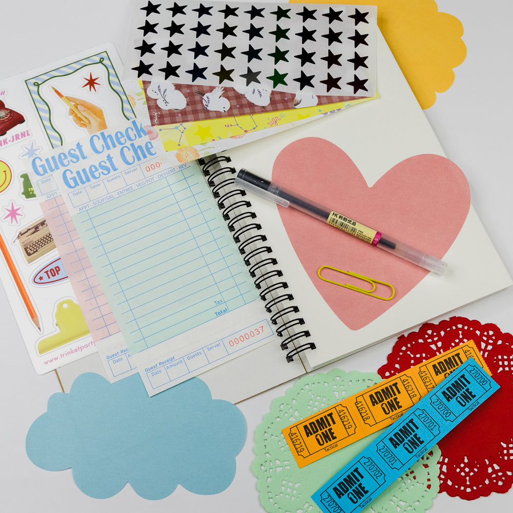 Notebook with colorful stickers and a pen on a white background