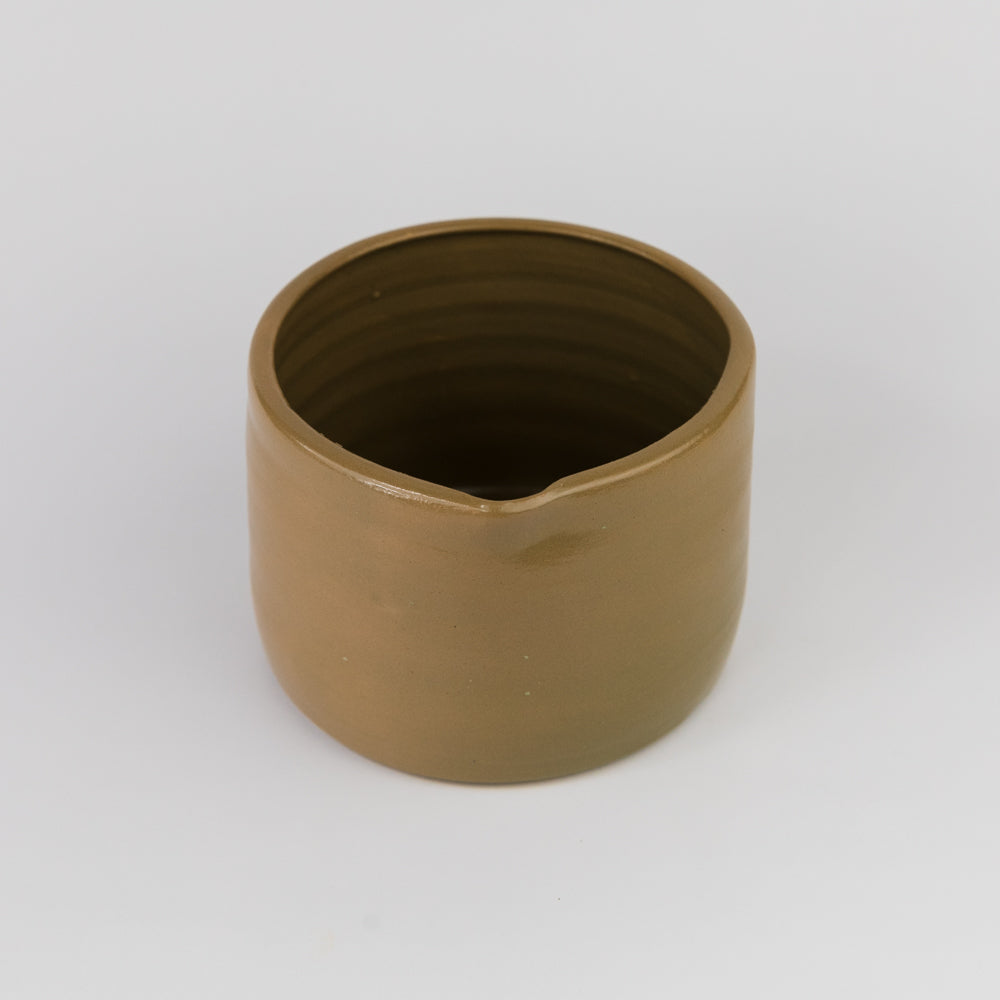 Bronze-colored cylindrical object on a white background