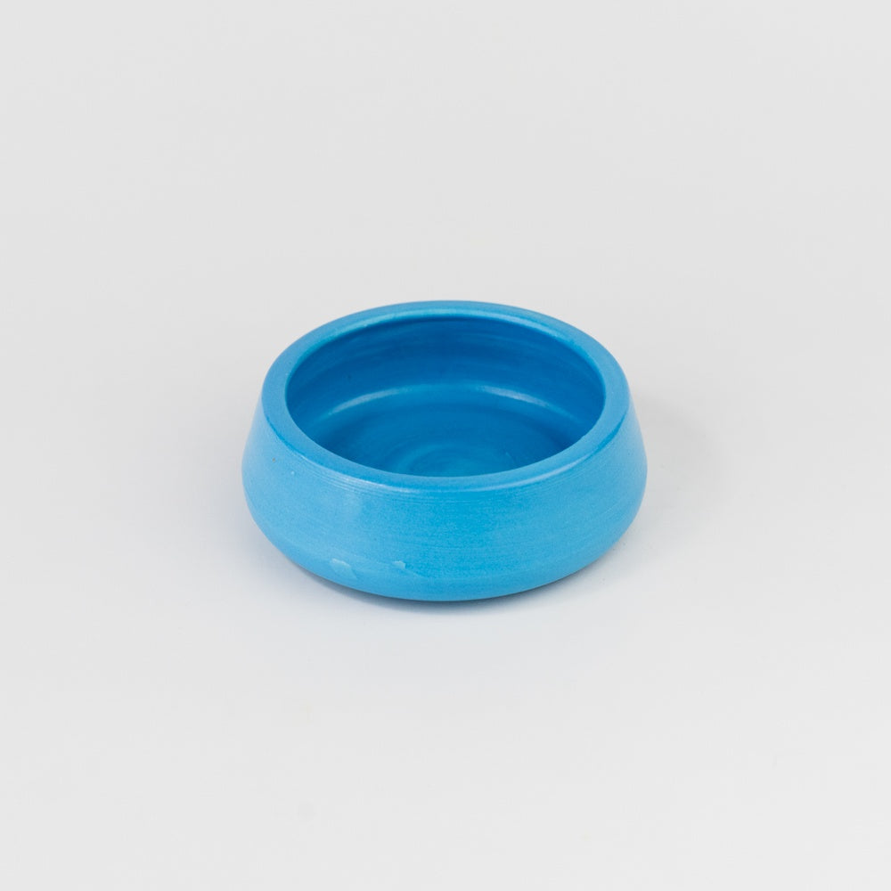 Blue ceramic bowl on a light gray background