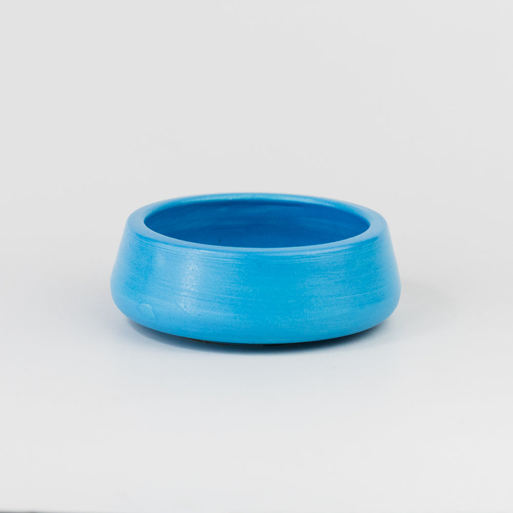 Blue ceramic bowl on a light gray background