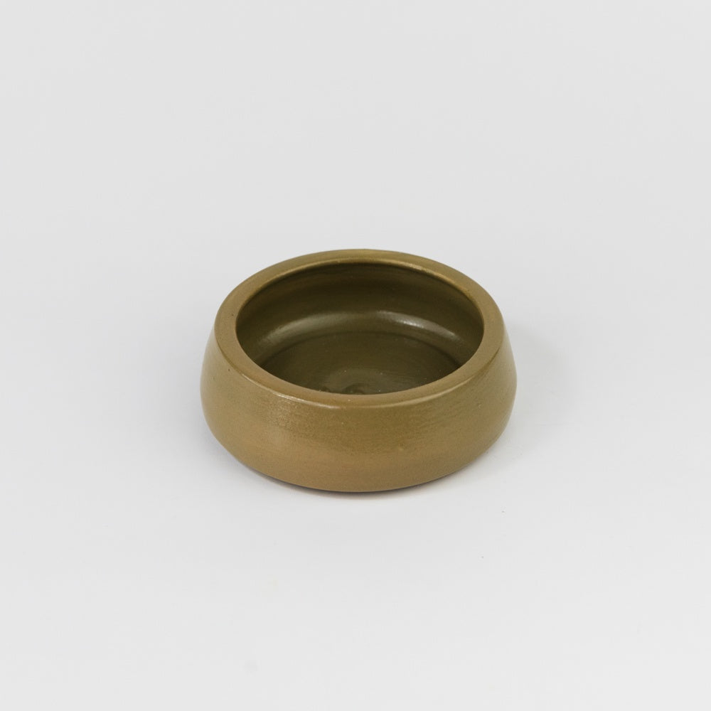 Bronze-colored ceramic bowl on a white background