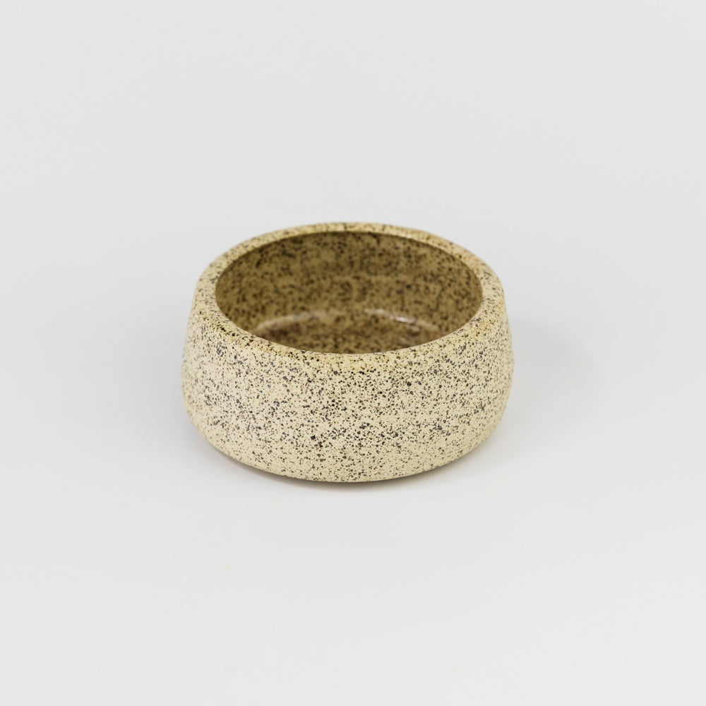 Speckled ceramic bowl on a white background