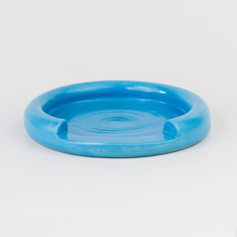 Blue ceramic dish on a light gray background