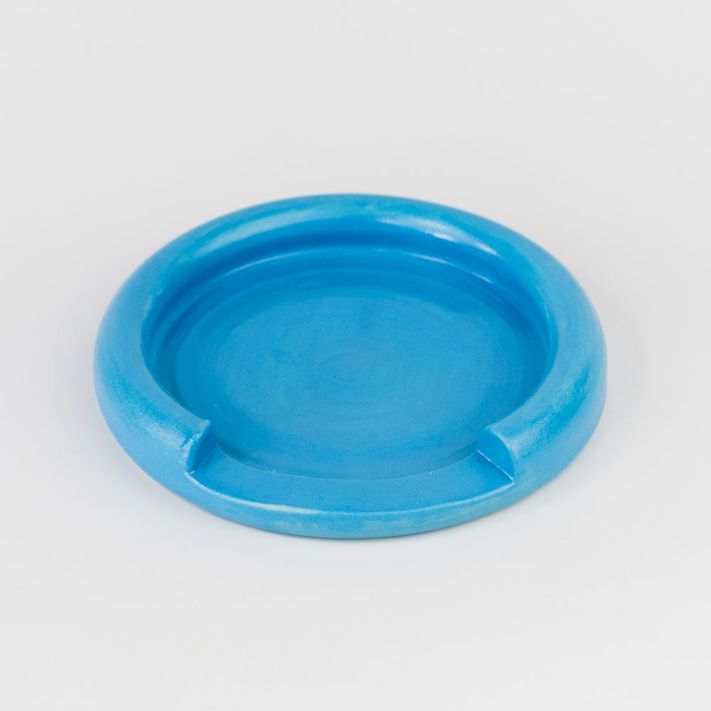 Blue ceramic dish on a light gray background