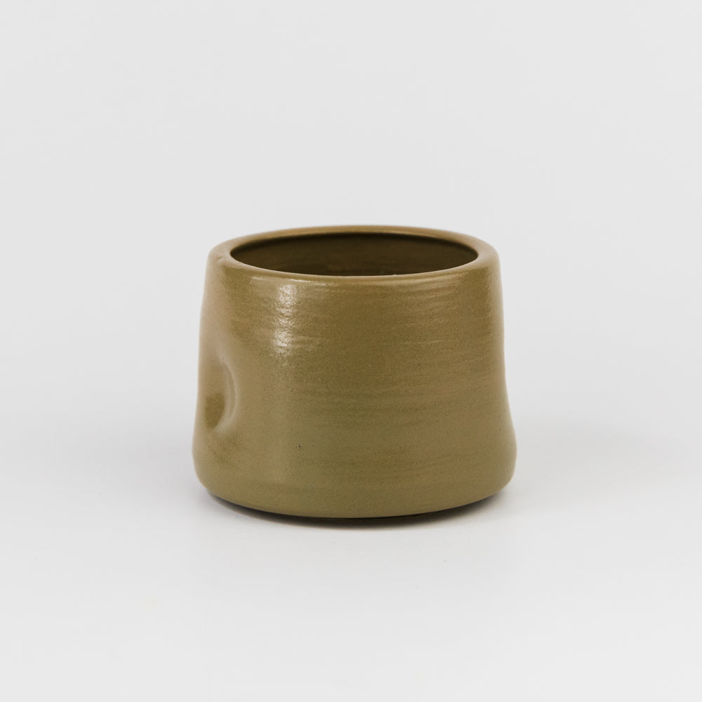 Brown ceramic cup on a white background