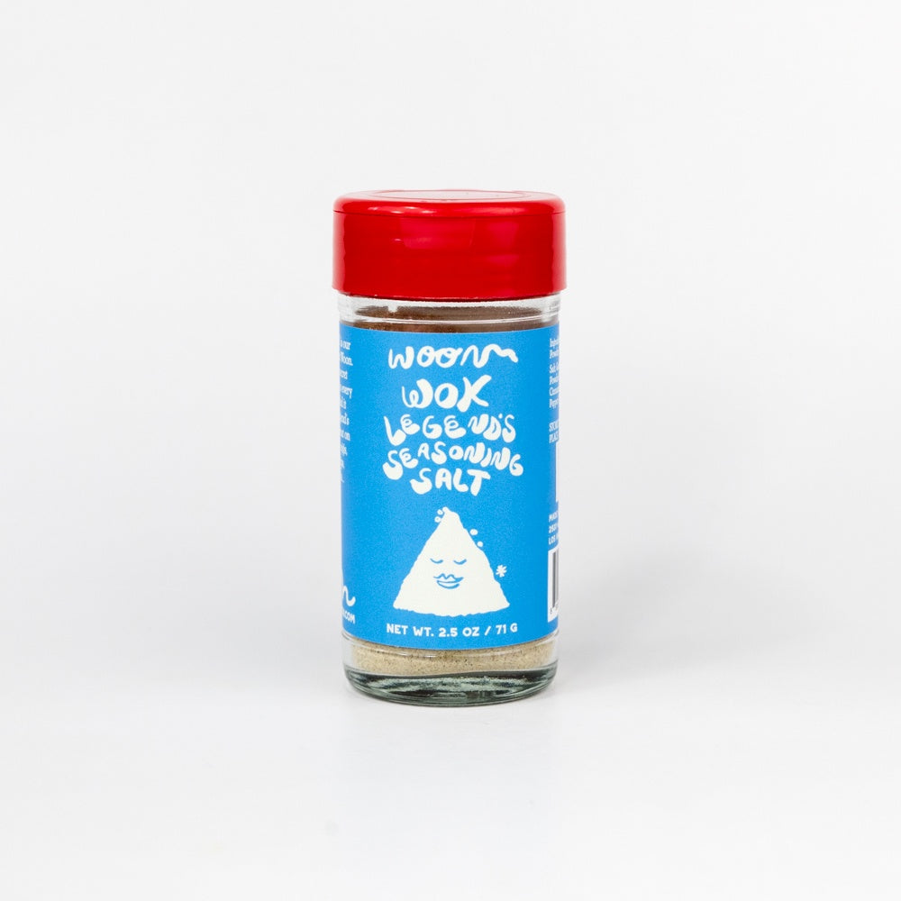 Jar of seasoning salt with a blue label and red lid on a white background