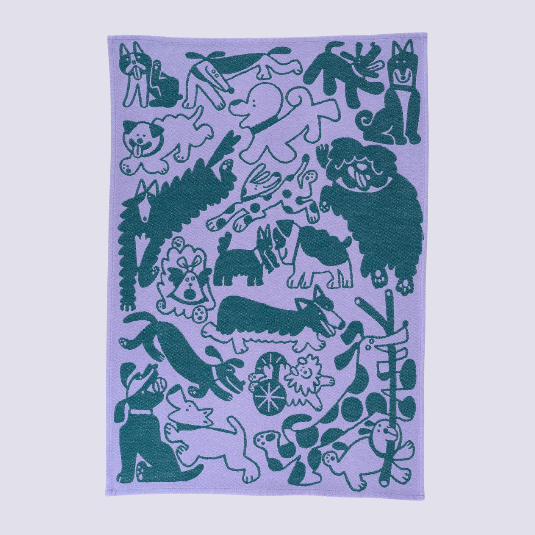 Product packaging with 'Dogs Day Out' text and dog illustrations on a light purple background