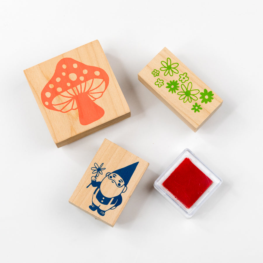 Set of rubber stamps with mushroom, flower, and gnome design on a white background