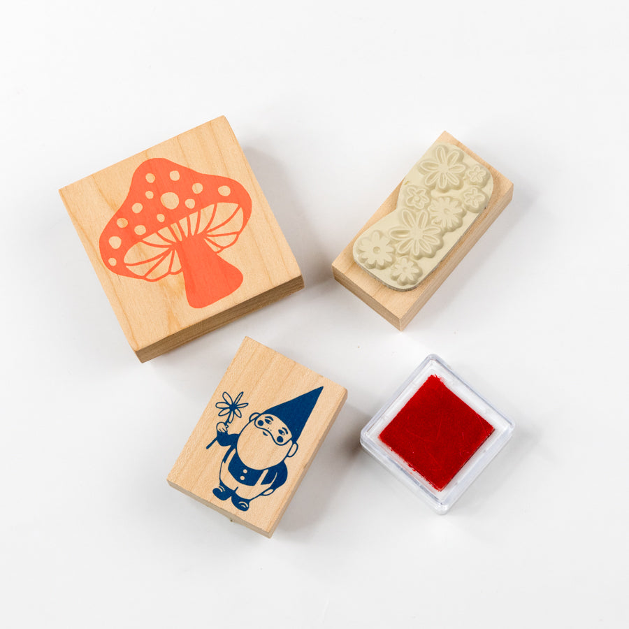 Three wooden stamps with different designs on a white background