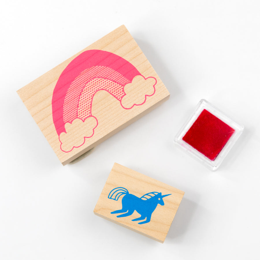 Rubber stamp set with a unicorn design and red ink pad in packaging on a white background