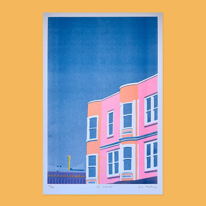 SF Corner Risograph Print is a florescent  pink and orange building with a blue sky backdrop 